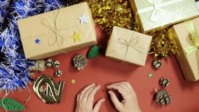 festive scene featuring hands forming  '2026' numbers, surrounded by wrapped gifts, pine cones, tinsel, and twinkling lights—evoking celebration, family, and holiday cheer - Powered by Shutterstock - Get 15% off with code: PIKWIZARD15