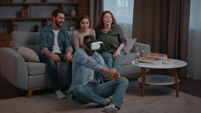 Four diversity ethnic friends at home party African american Latina man playing VR battle buddies men women saupporting applauding motivating virtual reality technology AR headset metaverse game using - Powered by Shutterstock - Get 15% off with code: PIKWIZARD15