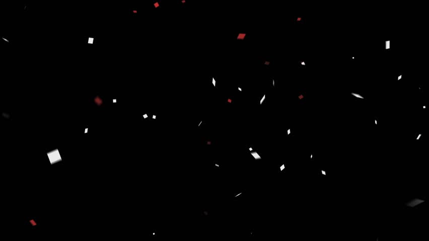 A festive explosion of white and red confetti pieces falls gracefully against an isolated black background. For celebrations and events