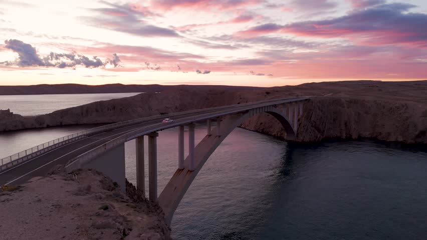 Cinematic Aerial Sunset over Pag Bridge, Croatia – Stunning Drone Footage of Island Coastline and Adriatic Sea. Croatia Aerial. The drone captures the golden light over the Adriatic Sea