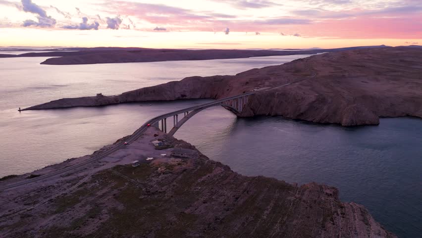 Cinematic Aerial Sunset over Pag Bridge, Croatia – Stunning Drone Footage of Island Coastline and Adriatic Sea. Croatia Aerial. The drone captures the golden light over the Adriatic Sea