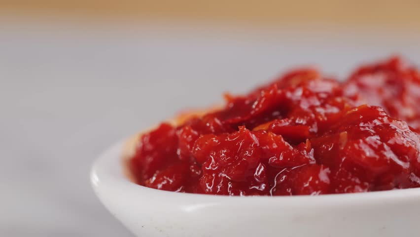 Red pasta of red hot chilli commonly called sambal in spoon, hungarian hot sauce with pepper. 