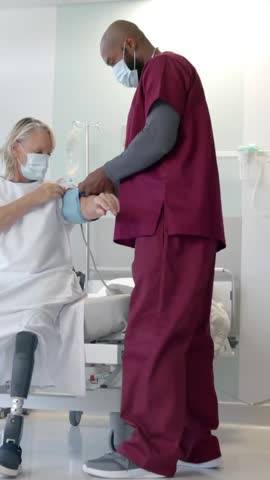 Animation of dna strand rotating over diverse male doctor taking pulse of senior female patient. Check up, digital interface, connection, hospital and healthcare, digitally generated video.