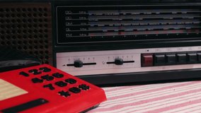Retro vintage red phone, telephone is displayed on a wooden desk, adding a nostalgic touch. Man answer for call on button 90 phone.  - Powered by Shutterstock - Get 15% off with code: PIKWIZARD15