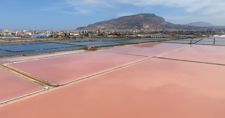 Aerial view of the Trapani salt pans, in Sicily, Italy. Mount Erice is in the background on the horizon