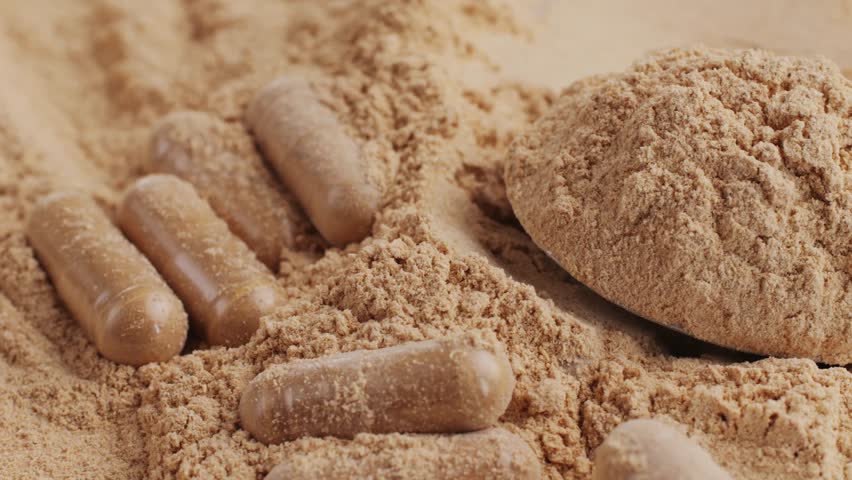 Ashwagandha Indian Ginseng Powder in White Bowl isolated on white background, superfood close up. 