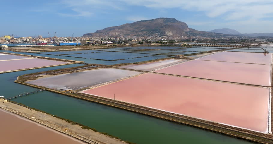 Aerial view of the Trapani salt pans, in Sicily, Italy. Mount Erice is in the background on the horizon