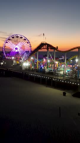 Santa Monica Pier At Los Angeles In California United States. Colored Amusement Park Pier. Ferris Wheel Landscape. Santa Monica Pier At Los Angeles In California United States.
