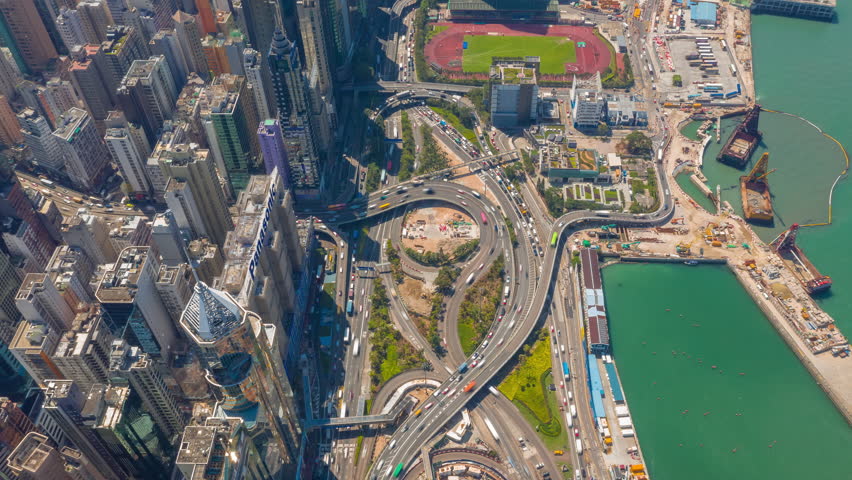 sunny day flight over hong kong city downtown traffic bay construction aerial topdown panorama 4k timelapse