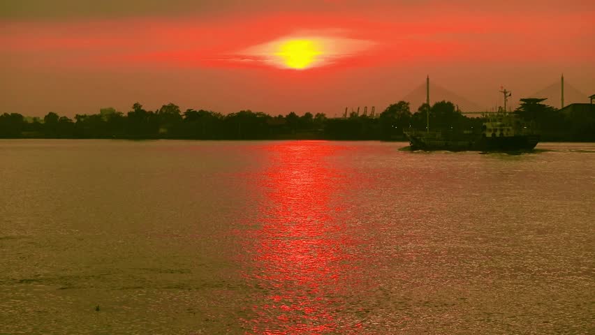 Footage of a Tugboat Sailing under Stunning Vivid Golden Orange Sunset Sky