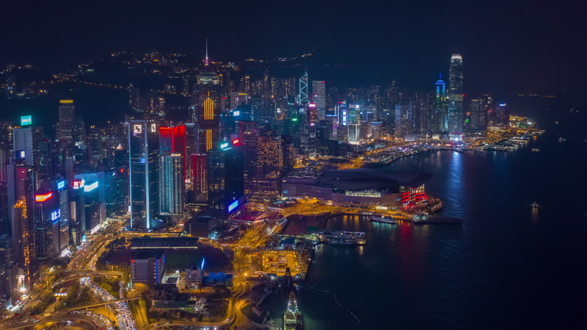 night illuminated flight over hong kong city downtown traffic jam aerial panorama 4k timelapse