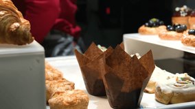 A display case in a supermarket with a variety of puff pastry including croissants and other puff pastry with various fillings. The display case features various puff pastry buns and pastries. - Powered by Shutterstock - Get 15% off with code: PIKWIZARD15