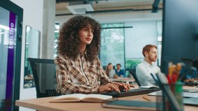 Caucasian woman listening attentively while red-haired male colleague asking questions and gesturing toward screen. Team discussing work details in bright collaborative modern office environment. - Powered by Shutterstock - Get 15% off with code: PIKWIZARD15