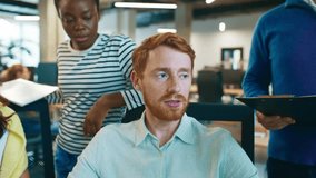 Team of diverse coworkers discussing project at workplace. Man pointing at computer screen explaining task while colleagues listening and taking notes. Group collaborating in modern office environment - Powered by Shutterstock - Get 15% off with code: PIKWIZARD15