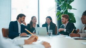 Focused business team gathered around laptop analyzing report data. Colleagues reviewing charts and searching for calculation errors during meeting. Serious collaboration in office workspace. - Powered by Shutterstock - Get 15% off with code: PIKWIZARD15