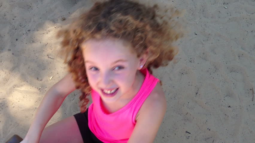 Little girl playing at playground with wood horse