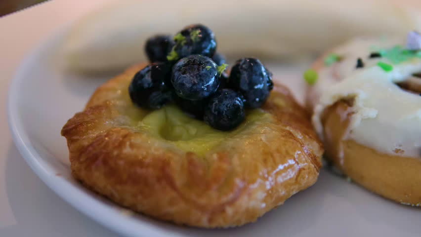 Pastry blueberries icing Dessert table with sweet pastries and mousse cakes. Concept of exquisite confectionery.