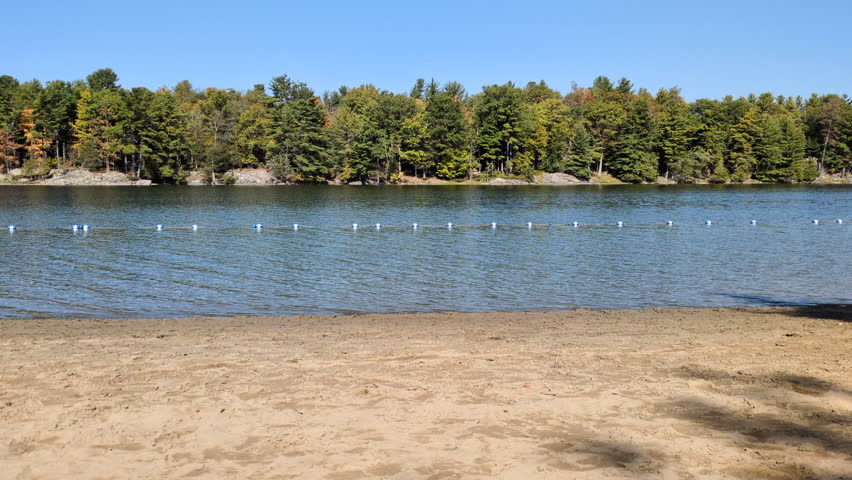 A beach of the Charleston Lake Provincial Park with the Whitefish Island in background in the Running’s bay of the Charleston lake (Lansdowne, Ontario, Canada)