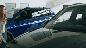 Excited woman enjoys new car at auto salon for millennials seeking lease options - Powered by Shutterstock - Get 15% off with code: PIKWIZARD15