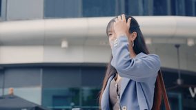 Young business businesswoman walking outdoor, focused on mobile phone while traveling, modern office buildings backdrop, urban professional woman navigating bustling city street environment. - Powered by Shutterstock - Get 15% off with code: PIKWIZARD15