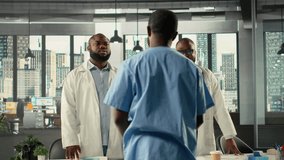 Medical staff in hospital office participating in a clinical discussion on diagnosis and treatment. Doctors and nurses analyze healthcare data and coordinate strategies. Camera B. - Powered by Shutterstock - Get 15% off with code: PIKWIZARD15