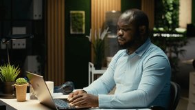 African american staff member distraught thinking about new ideas to impress the board, creating a presentation to help with development. Reflect about decisions and pushing limits. Camera B. - Powered by Shutterstock - Get 15% off with code: PIKWIZARD15