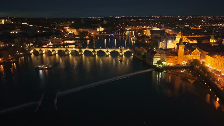 Aerial night view of Charles Bridge and Prague Castle with emergency lights in Prague, Czech Republic