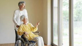 Senior man caring for senior woman in wheelchair - Powered by Shutterstock - Get 15% off with code: PIKWIZARD15