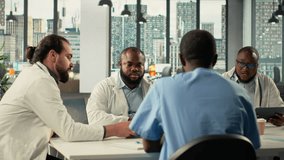 Surgeons and medical staff in a clinic discussing therapy options and research analysis. The meeting highlights professionalism, coordination and innovation in healthcare planning. Camera B. - Powered by Shutterstock - Get 15% off with code: PIKWIZARD15