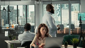 Diverse employee recording marketing ad for web advertisement in office, broadcasting live while coworkers solve their business tasks. Professional people forecasting for productivity. Camera B. - Powered by Shutterstock - Get 15% off with code: PIKWIZARD15