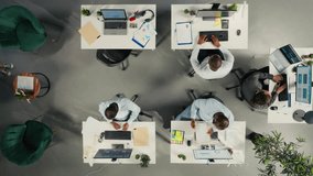 Top down view zoom in of business colleagues using computers to analyze insights and performance metrics, making projections and data visualization. Reports for corporate development. Camera A. - Powered by Shutterstock - Get 15% off with code: PIKWIZARD15