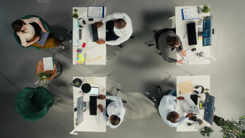 Time lapse top down view zoom in of diverse work team study analytics and forecasting, focus on performance metrics and report writing. Data visualization to support management decisions. Camera A. - Powered by Shutterstock - Get 15% off with code: PIKWIZARD15