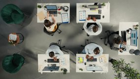 Top down view zoom in of business people review diagrams during report writing. Colleagues in multinational company share insights and coordinate tasks using pc and visual data tools. Camera A. - Powered by Shutterstock - Get 15% off with code: PIKWIZARD15