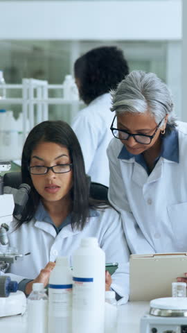 Woman, science team and microscope at laboratory with tablet, planning and medical research project. People, tech and checklist on application, insight and talk with solution for pharmaceutical study