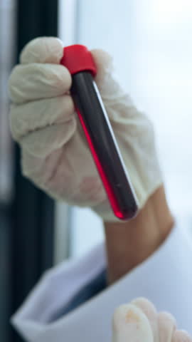 Blood, sample and hands in lab with scientist for medical research, genetic mapping and investigation. Science, doctor person and vial for DNA study, analysis and scientific experiment for healthcare