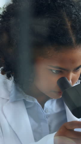 Scientist, woman and microscope in lab with inspection for sample analysis, biotech or stem cell research. Bokeh, person and equipment for science, medical innovation and cure development for cancer.