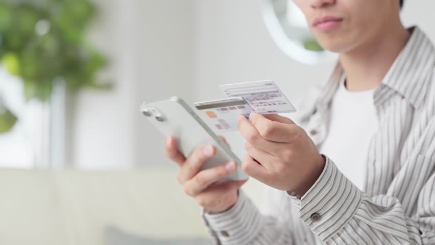 Asian man setting up his Myna health insurance card