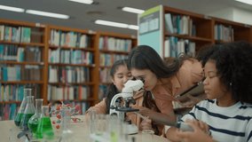 Teacher guiding two elementary students in a science experiment, using a microscope to observe specimens in a modern classroom, promoting scientific learning and education - Powered by Shutterstock - Get 15% off with code: PIKWIZARD15