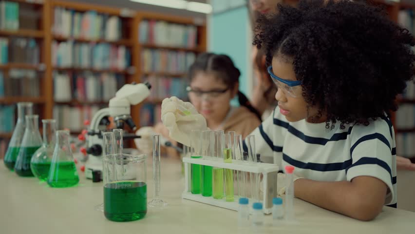 Elementary school students engaged in a science lesson, actively using experiment tools and equipment in the classroom for hands-on learning and education