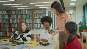 Female teacher teaching high school students in a robotics and technology class, collaboratively building a robot for a engineering project - Powered by Shutterstock - Get 15% off with code: PIKWIZARD15