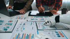 During a business meeting, a consultant and an assistant use an artificial intelligence AI assistant for data analytics, marketing, research, collaboration, and plan using technology. Noogenesis AI - Powered by Shutterstock - Get 15% off with code: PIKWIZARD15