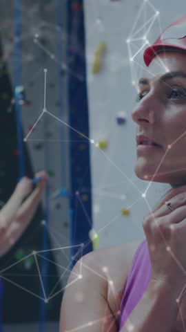 Animation of data processing over caucasian women climbing wall. Global sports, science, computing, digital interface and data processing concept digitally generated video.
