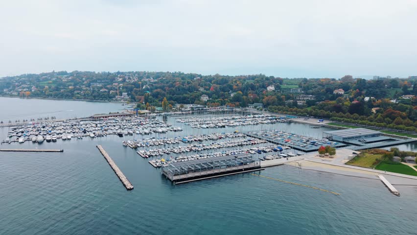 Aerial view of boats docked at Quai Gustave-Ador with blue water contrasting the greenery of the coast, Port-Noir, Geneva, Switzerland.