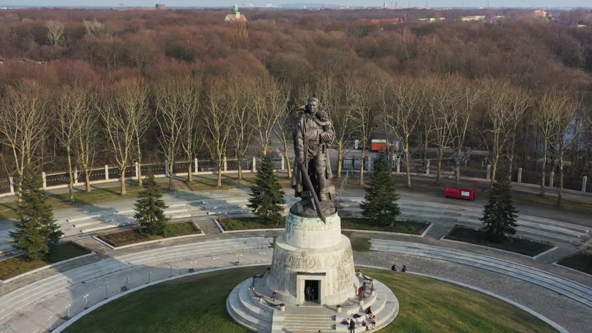 Aerial view of the Soviet War Memorial Tiergarten, a monumental bronze statue rising from the lush green circular lawn, Berlin, Berlin, Germany.