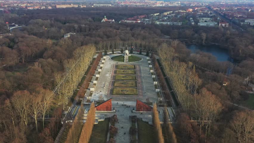 Aerial view of the Soviet War Memorial in Treptower Park, showcasing a monumental sculpture surrounded by autumn foliage, Berlin, Berlin, Germany.