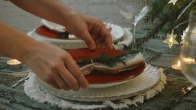 Female hands set the table, preparing dishes for a festive Christmas dinner - Powered by Shutterstock - Get 15% off with code: PIKWIZARD15