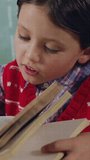 Child reading book with data processing animation over classroom background. Education, technology, learning, innovation, digital, futuristic - Powered by Shutterstock - Get 15% off with code: PIKWIZARD15