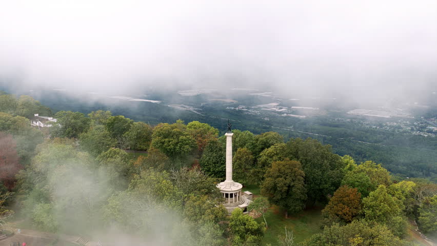 Morning fog drifts across Lookout Mountain as the Point Park monument rises above the trees overlooking the Tennessee Valley.