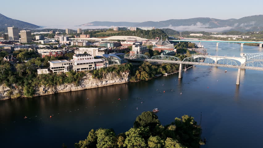 The Tennessee River sparkles as swimmers and kayaks weave between Chattanooga’s bridges with Lookout Mountain in the distance.