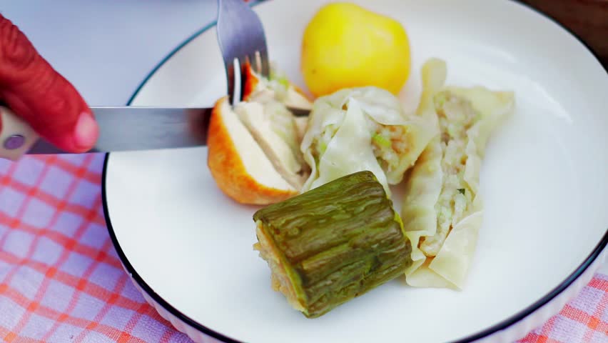Traditional Indonesian siomay being sliced on a plate, showcasing delicious local street food and culinary culture.